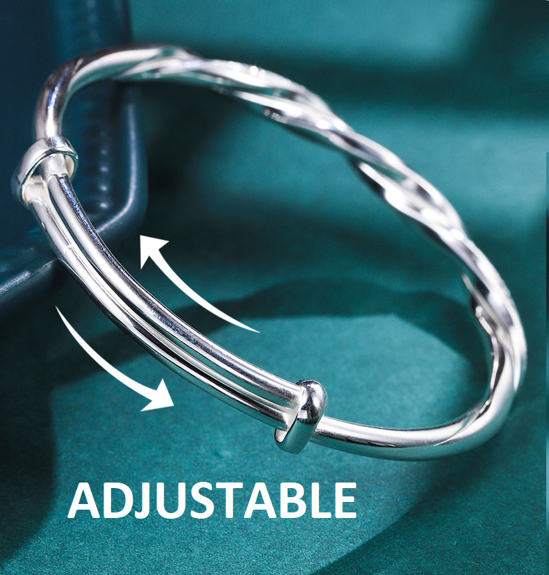 "Elegante gedraaide zilveren armband voor dames, verstelbaar, met glanzende afwerking en modern ontwerp"
