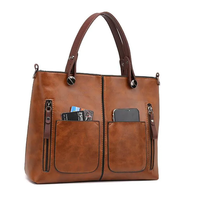 "Elegante leren schoudertas met magnetische sluiting, duurzaam bruin leer, verstelbare riem voor draagcomfort."