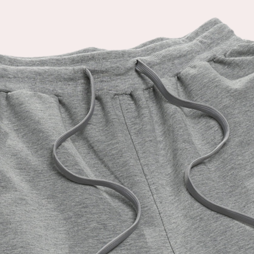 "Lichte heren joggingbroek, katoen, comfortabele pasvorm, elastische taille, moderne wijde pijpen, minimalistische stijl."