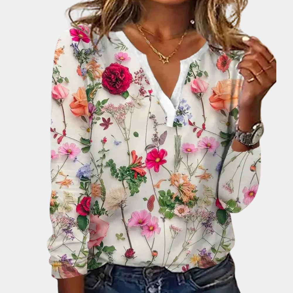 "Luchtige casual damesblouse met kleurrijk bloemmotief, perfect voor zomer; combineerbaar met jeans of rokken."
