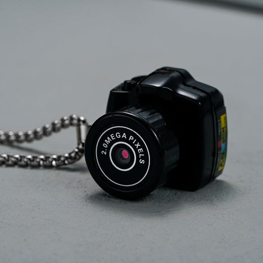 "Compacte HD mini videocamera, draagbaar ontwerp met schokbestendige behuizing, ideaal voor scherpe 1080HD opnamen."