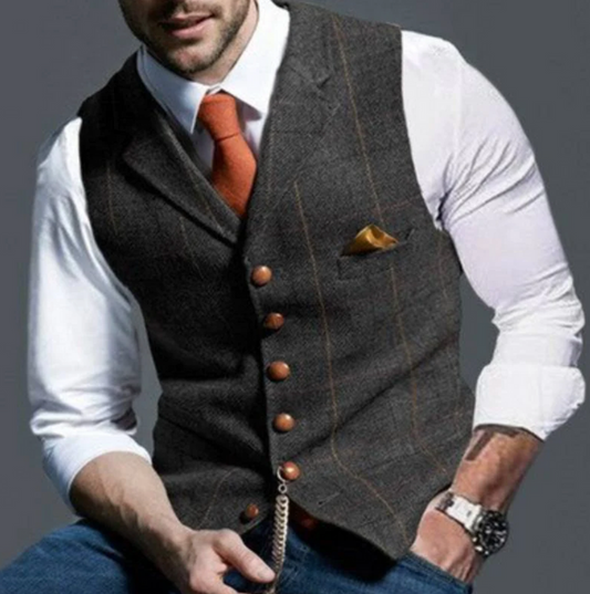 "Elegant donkergrijs herengilet van tweedstof, klassiek en veelzijdig, ideaal voor zowel formele als casual gelegenheden."