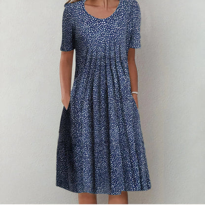 "Elegante blauwe katoenen jurk met bloemmotief, vloeiend silhouet, veelzijdig voor casual en formele gelegenheden."