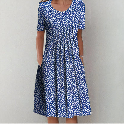 "Elegante blauwe katoenen jurk met bloemmotief, vloeiend silhouet, veelzijdig voor casual en formele gelegenheden."