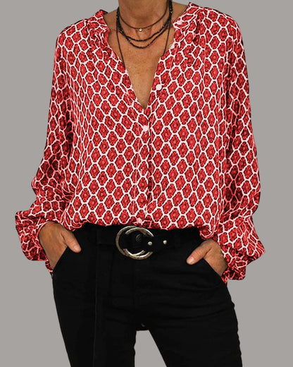 Elegante blouse met V-hals en geometrisch design, subtiele knoopdetails, ideaal voor zowel zakelijke als casual gelegenheden.
