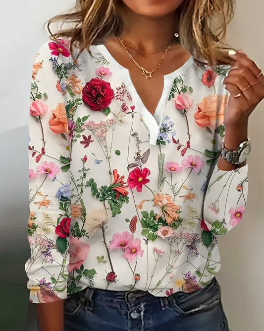 "Elegante Elisa blouse met bloemenpatroon, V-hals en lange mouwen, voor een verfijnde uitstraling in dameskleding."