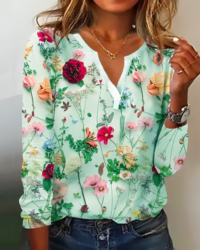"Elegante Elisa blouse met bloemenpatroon, V-hals en lange mouwen, voor een verfijnde uitstraling in dameskleding."