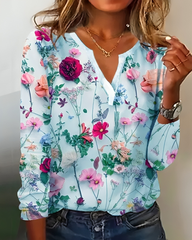 "Elegante Elisa blouse met bloemenpatroon, V-hals en lange mouwen, voor een verfijnde uitstraling in dameskleding."
