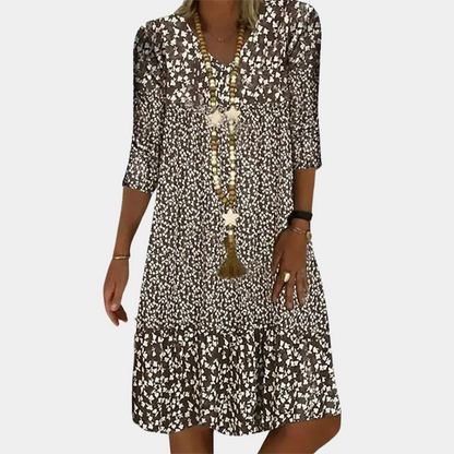 "Elegante Ottilie midi zomerjurk voor dames met V-hals, verfijnde pasvorm, ademende stof en levendige kleuren."
