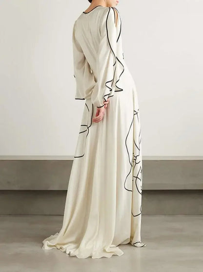 "Eline avondjurk met bloemenprint, gerimpelde mouwen en Falbala-details in witte en zwarte tinten, elegant ontwerp."
