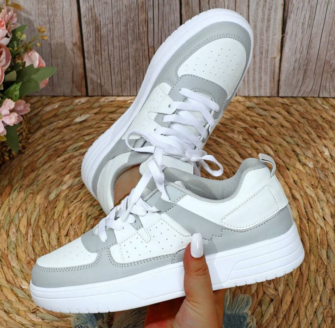 "Kleurrijke dames sneakers met wit, blauw, zwart en roze design, ademend materiaal en ergonomische pasvorm voor comfort."