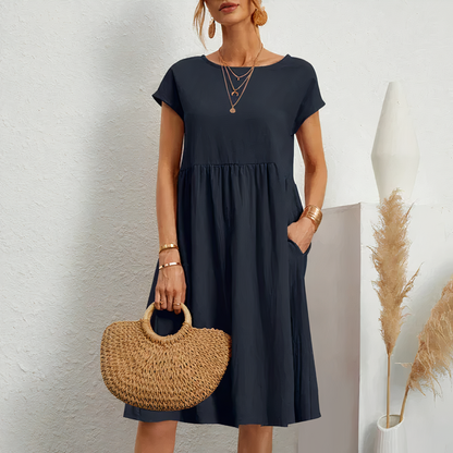 "Knielange zomerjurk met zakken, veelzijdige beige jurk voor dames, luchtige katoenen stof perfect voor zomerse dagen."