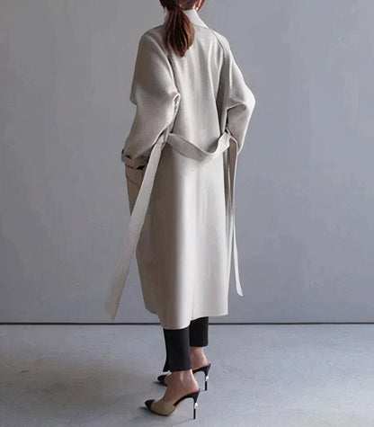 "Lange elegante wollen damesjas in het grijs, warmtehoudend en tijdloos, perfect voor stijlvolle winterlooks."