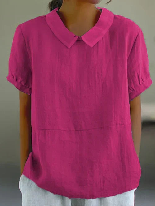 "Lichtblauwe Avaya blouse van katoen met korte mouwen, ronde kraag en subtiele details, ideaal voor zomerse dagen."