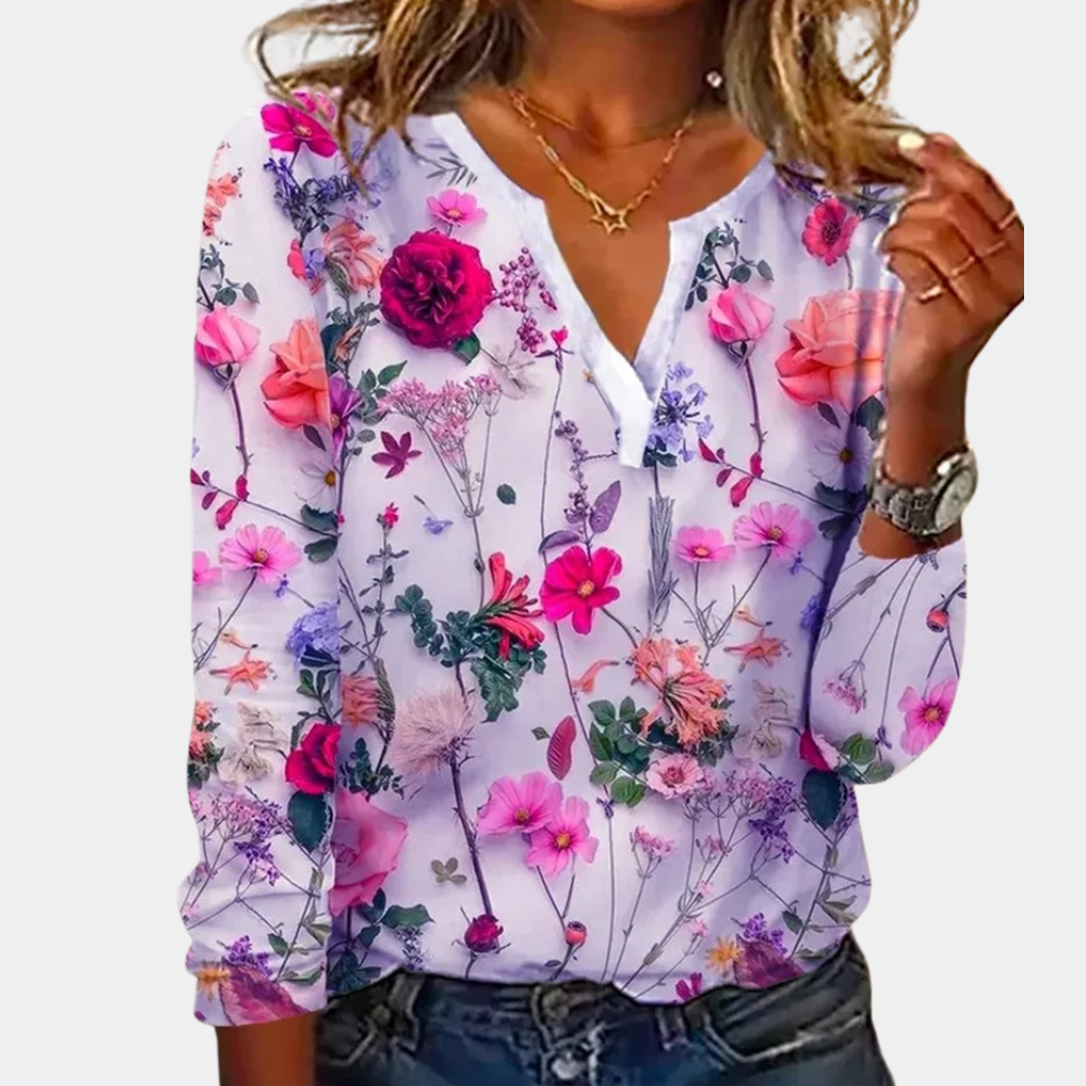 "Luchtige casual damesblouse met kleurrijk bloemmotief, perfect voor zomer; combineerbaar met jeans of rokken."