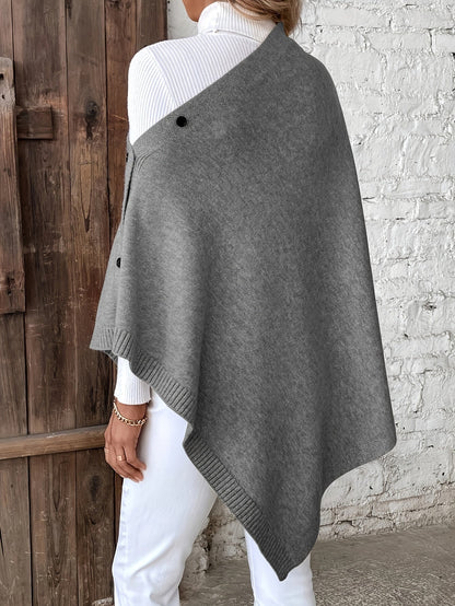 Luxe dames poncho met knoopsluiting, zachte stof, stijlvolle afwerking. Perfect voor casual en formele gelegenheden.