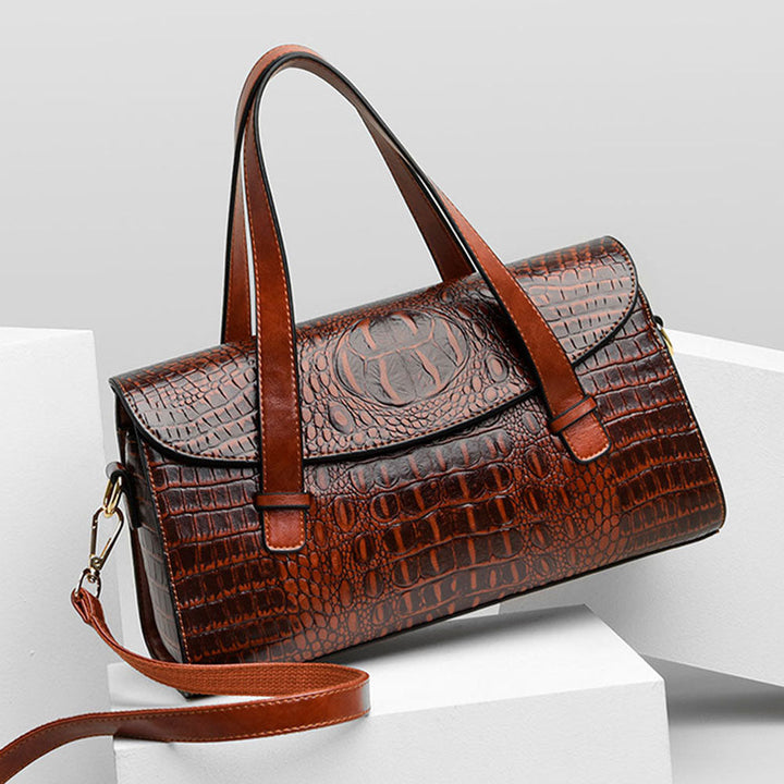 Luxe lederen damestas, bruin, elegant design met stevige handgrepen en verstelbare riem, voor dagelijks en zakelijk gebruik.