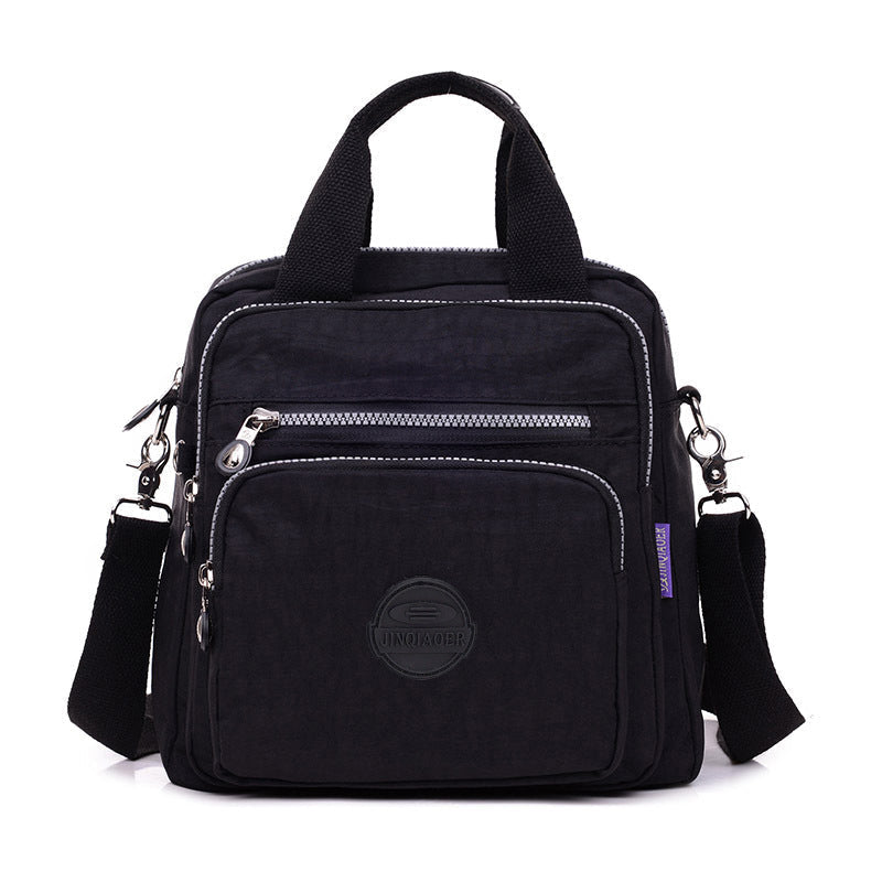 "Stijlvolle en praktische waterdichte nylon crossbody tas in zwart, met meerdere vakken en 3-weg gebruiksopties."