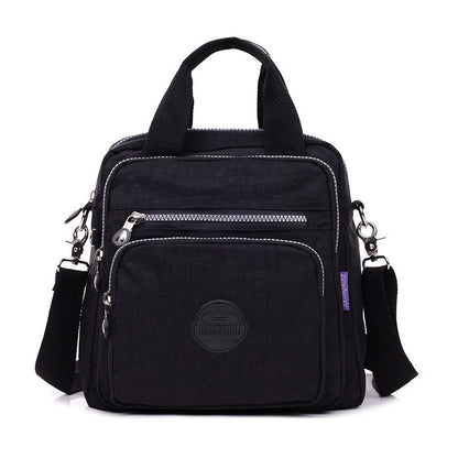"Stijlvolle en praktische waterdichte nylon crossbody tas in zwart, met meerdere vakken en 3-weg gebruiksopties."
