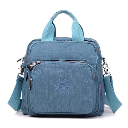 "Stijlvolle en praktische waterdichte nylon crossbody tas in zwart, met meerdere vakken en 3-weg gebruiksopties."
