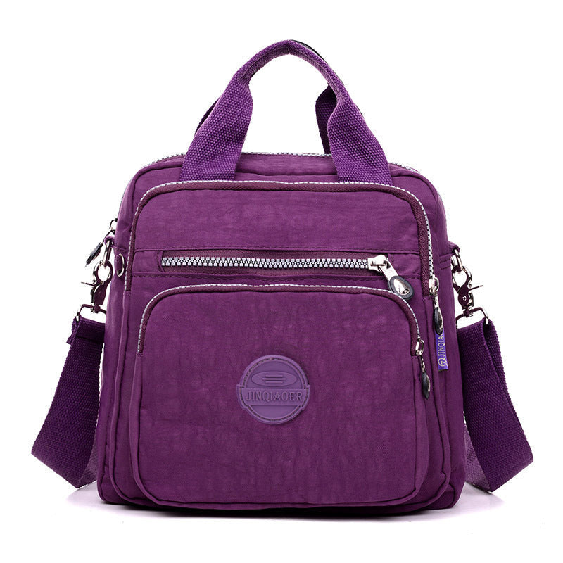 "Stijlvolle en praktische waterdichte nylon crossbody tas in zwart, met meerdere vakken en 3-weg gebruiksopties."