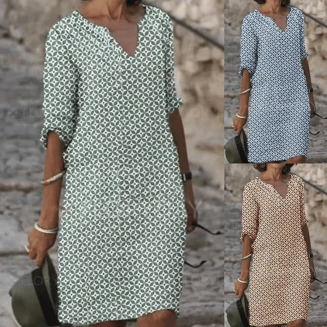 "Zomerjurk NORA: elegant ontwerp, ademende stof, verkrijgbaar in blauw, bruin, grijs, groen. Perfect voor zonnige dagen."