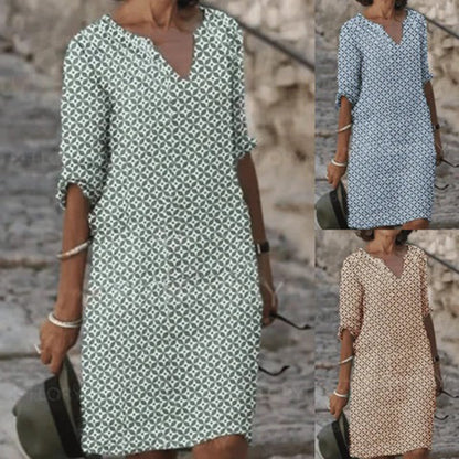 "Zomerjurk NORA: elegant ontwerp, ademende stof, verkrijgbaar in blauw, bruin, grijs, groen. Perfect voor zonnige dagen."
