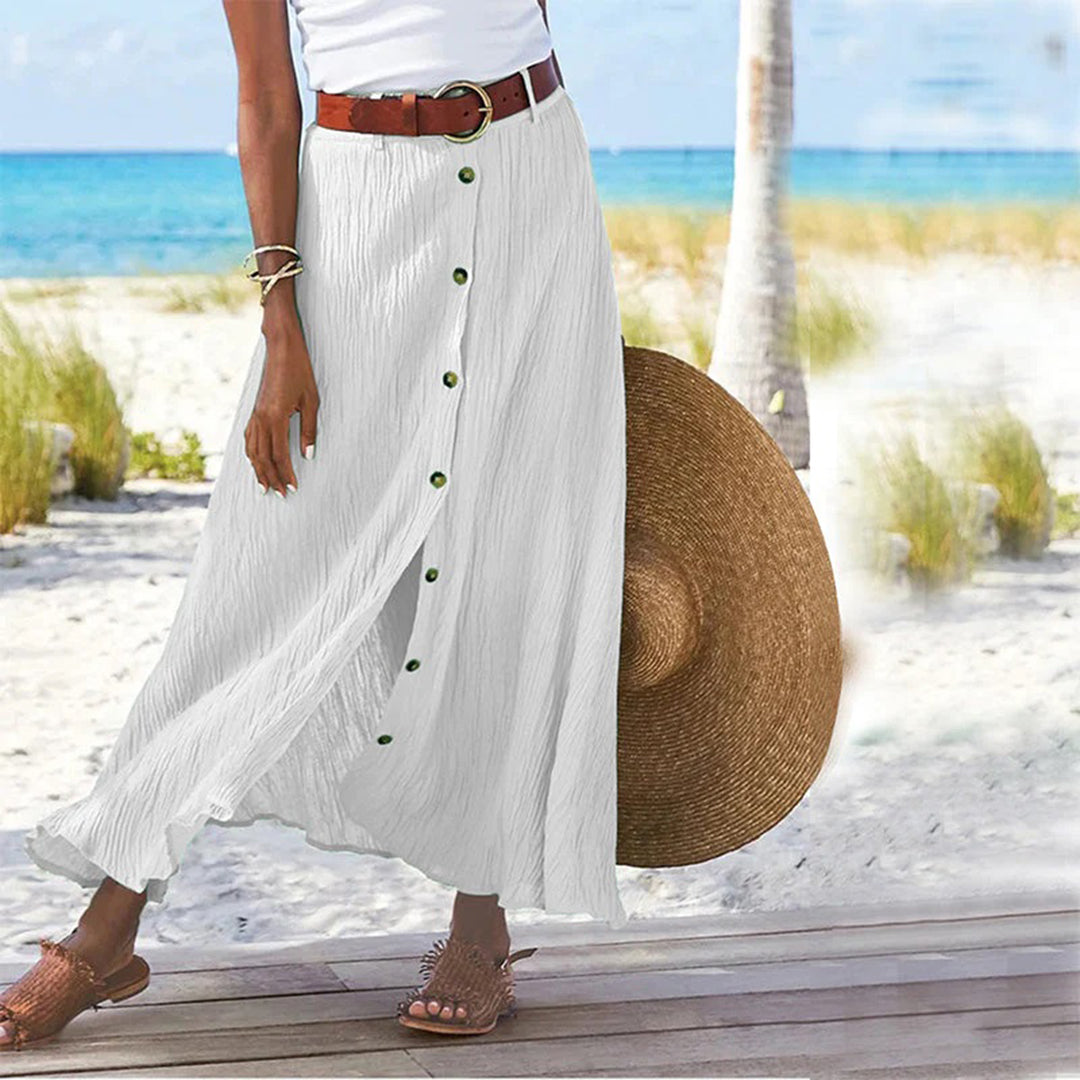 "Zomerse maxi-rok in groen; A-lijn silhouet met knoopdetails, ideale dameskleding voor warme dagen."