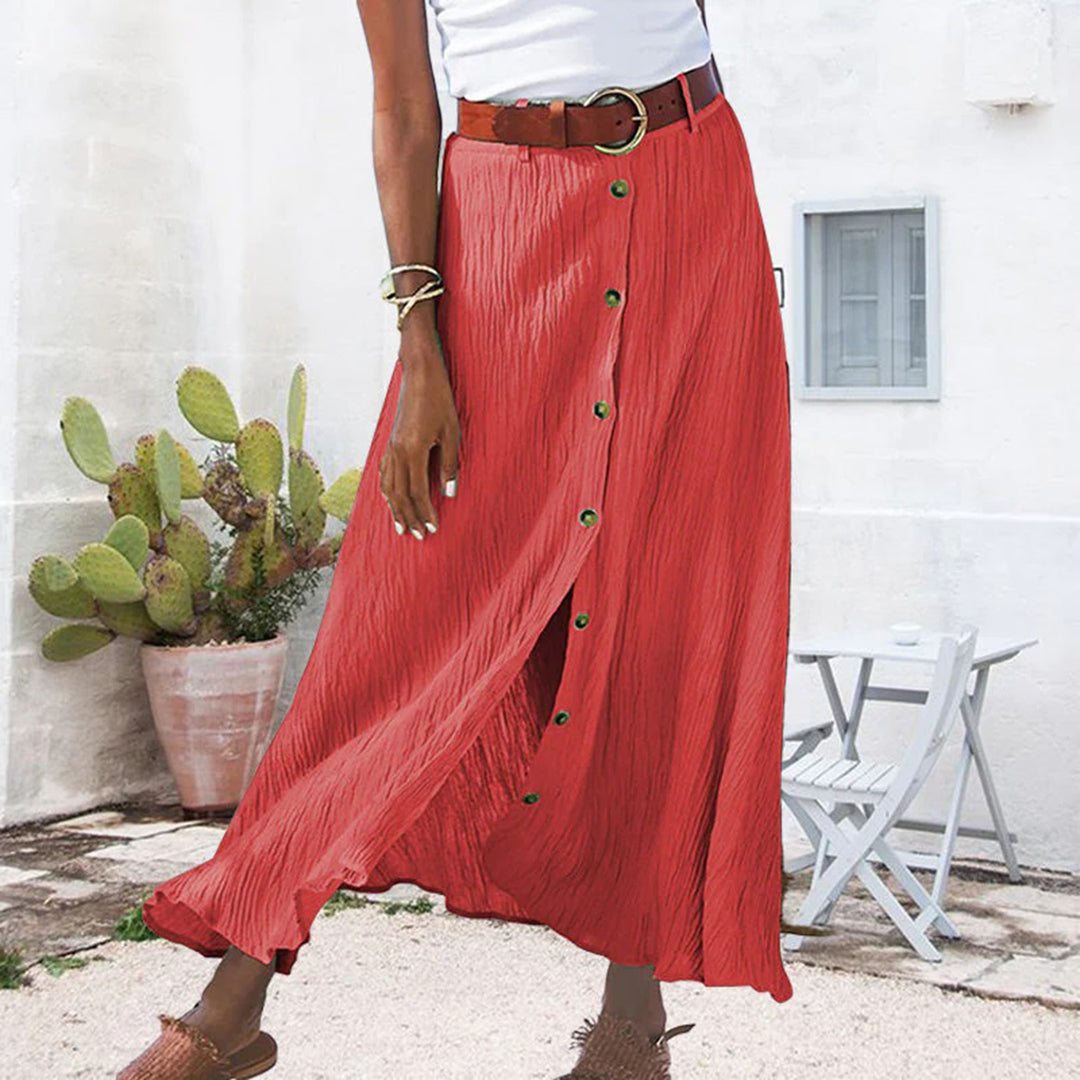 "Zomerse maxi-rok in groen; A-lijn silhouet met knoopdetails, ideale dameskleding voor warme dagen."