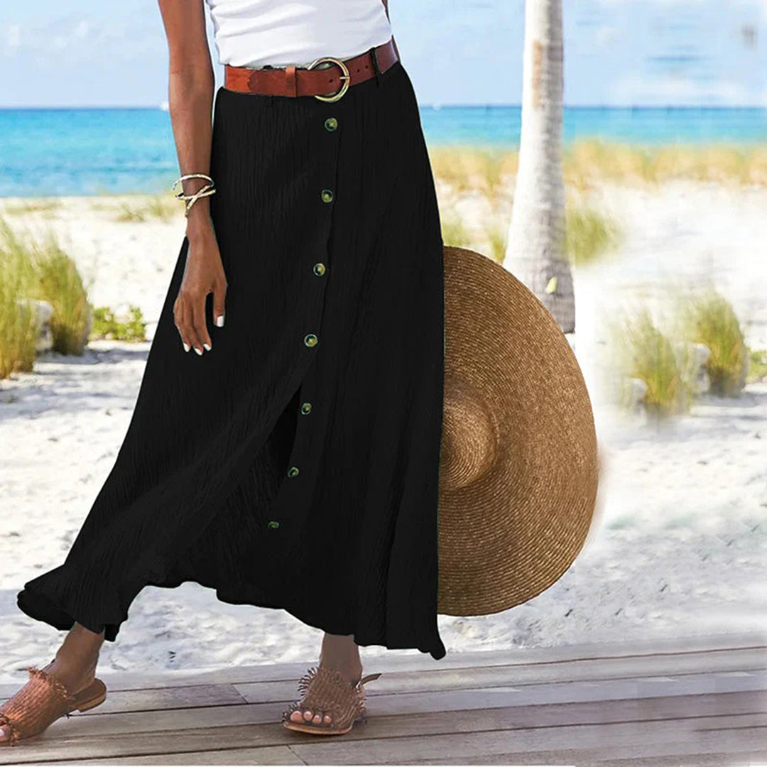"Zomerse maxi-rok in groen; A-lijn silhouet met knoopdetails, ideale dameskleding voor warme dagen."