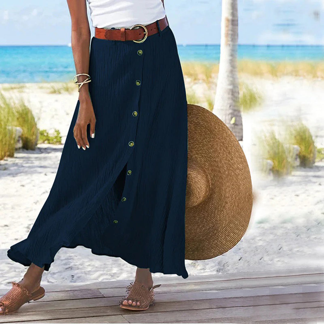"Zomerse maxi-rok in groen; A-lijn silhouet met knoopdetails, ideale dameskleding voor warme dagen."
